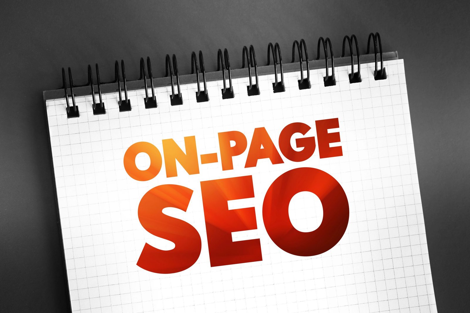 Block of paper written On-page SEO with red text on top